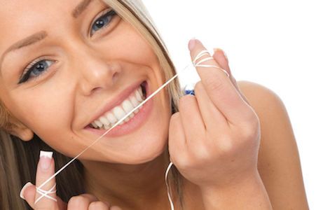 woman flossing her teeth