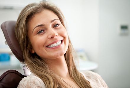 woman smiling after receiving a same day dental crown