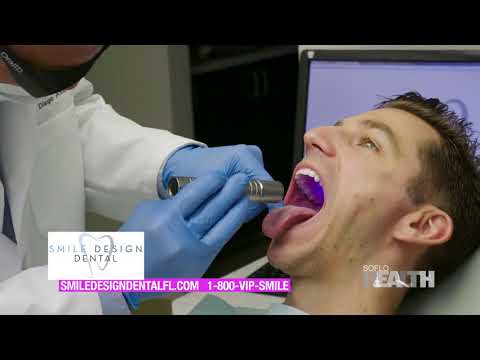 Dr Diego Azar looking into patients mouth